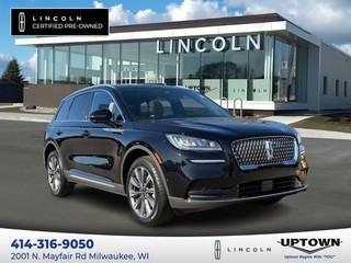 Vehicle image overlay showcasing Uptown Ford Lincoln Certified Pre-Owned models with a stunning dealership photo in Milwaukee, WI.